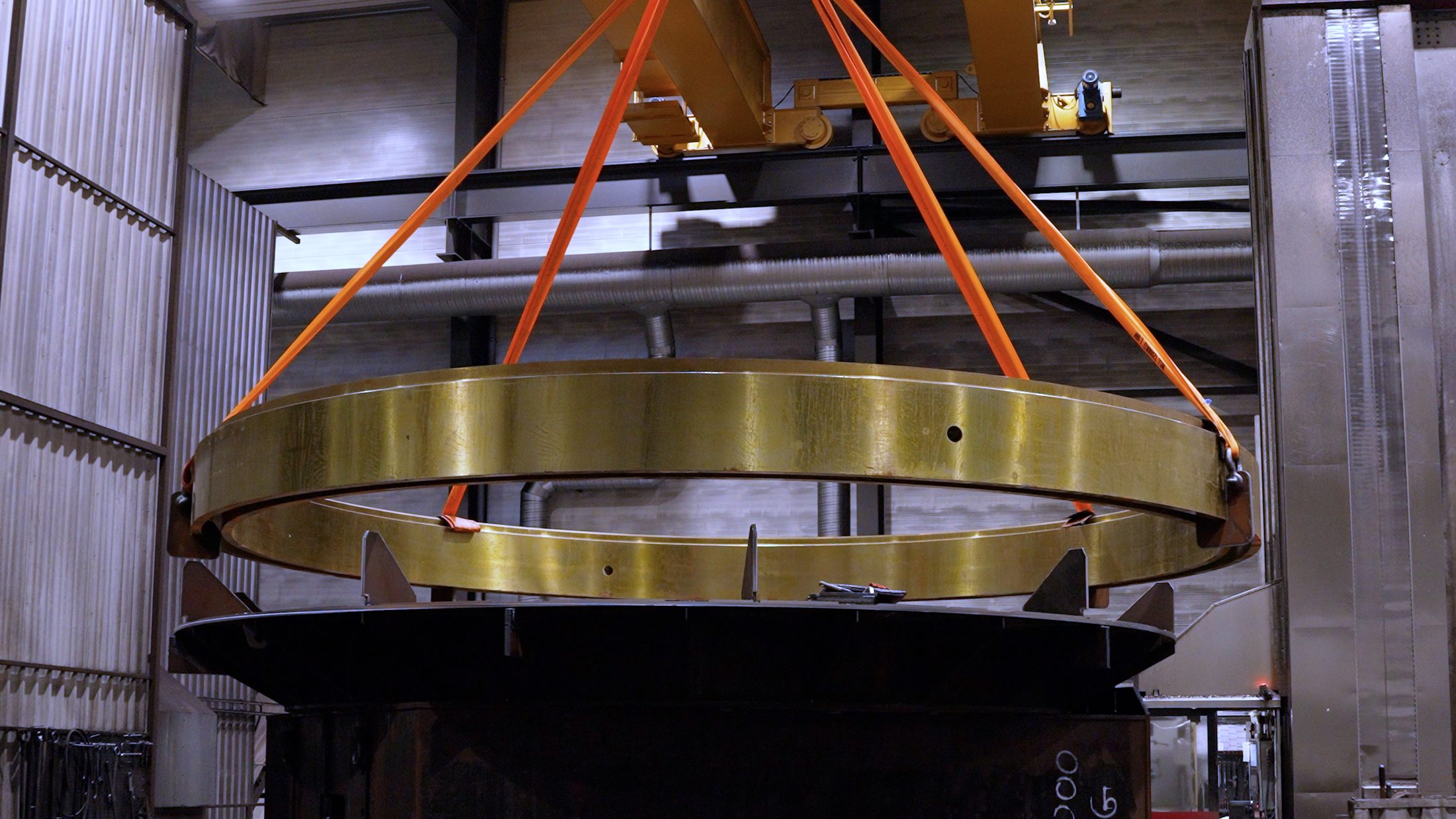 Large complex component lifted by crane